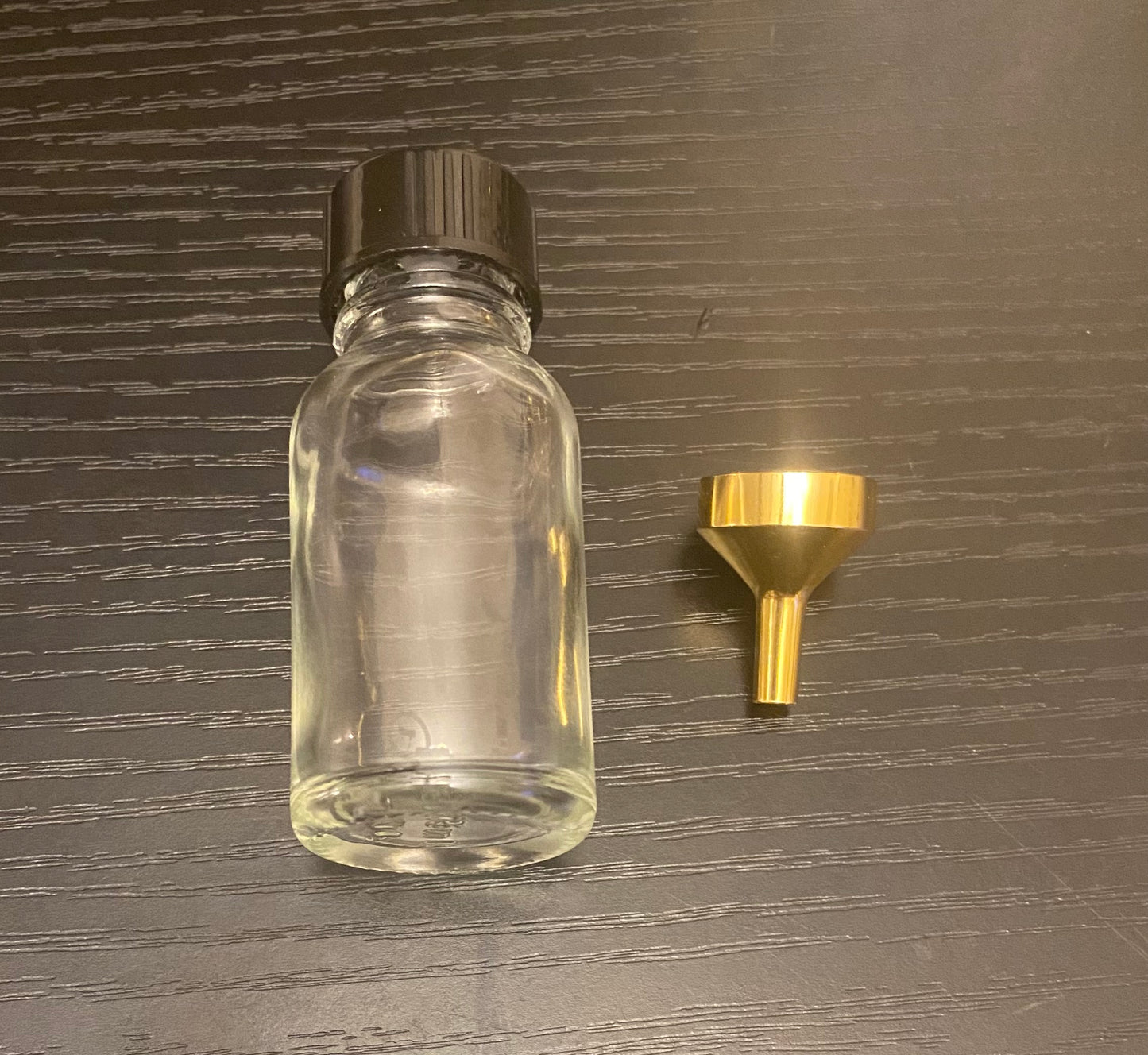 Oil bottle with funnel and fragrance oil